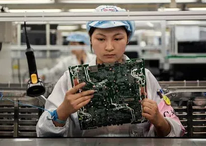 Technician inspecting electronics during barcode scanner production